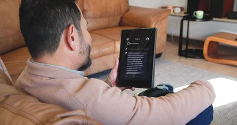 Mature Man Using Tablet on Sofa in Modern Living Room