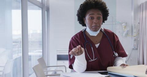 Healthcare Professional Writing Notes in Modern Hospital Setting