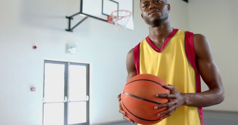 Young Basketball Player Holding Ball in Sports Facility - Download Free Stock Images Pikwizard.com
