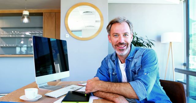 Smiling Middle-aged Man Working at Modern Office Desk - Download Free Stock Images Pikwizard.com