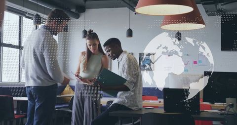 Diverse Team Analyzing Documents in Modern Open Office Setting