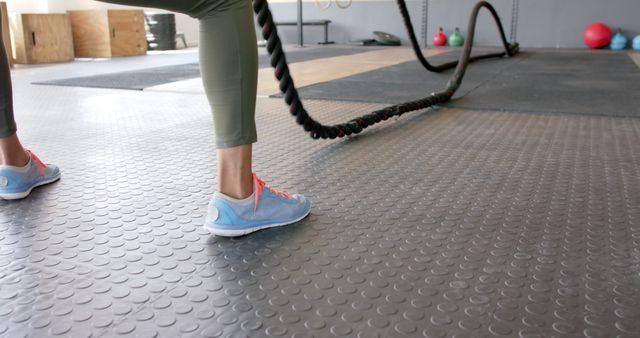 Focused Woman Exercising with Battling Ropes at Gym - Download Free Stock Images Pikwizard.com