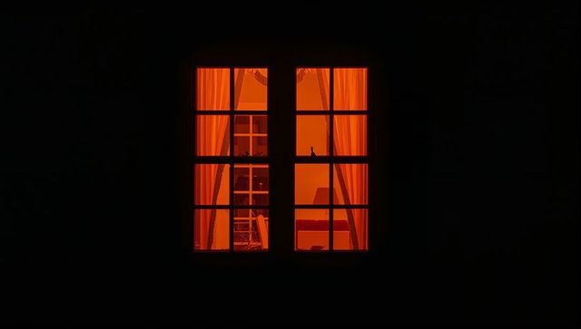 Cozy nighttime window with warm interior glow