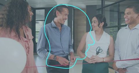 Business team cutting ribbon at office opening ceremony, celebrating new modern workspace