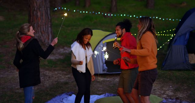 Friends Celebrating with Sparklers at Night While Camping - Download Free Stock Images Pikwizard.com