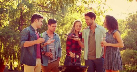 Diverse Group of Friends Enjoying Outdoor Barbecue Gathering