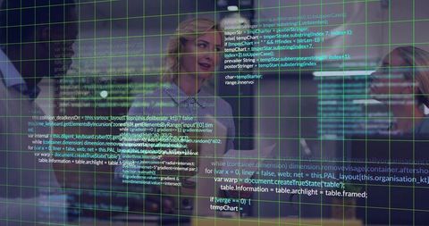 Coworkers collaborating over code on glass wall with green grid overlay and reflections