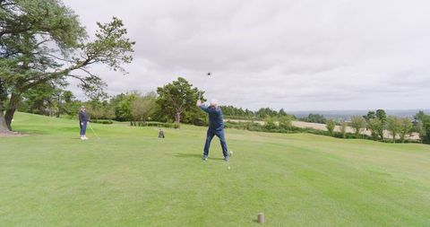 Senior golfers engaging in leisurely game on scenic outdoor course