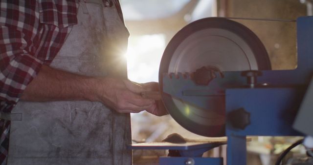 Artisan Sharpening Metal Tools on Grinding Wheel in Workshop - Download Free Stock Images Pikwizard.com