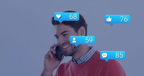 Young man holding smartphone smiling with social media notifications showing likes followers comment