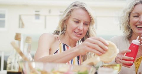 Family celebrating and enjoying outdoor summer barbecue