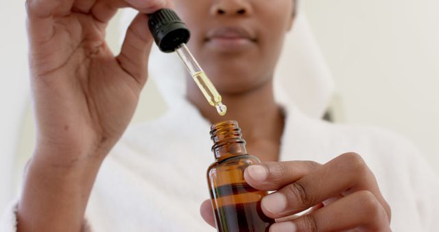 Woman Applying Serum with Dropper Bottle for Skincare Routine - Download Free Stock Images Pikwizard.com