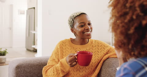 Happy Woman Enjoying Coffee and Conversation with Partner