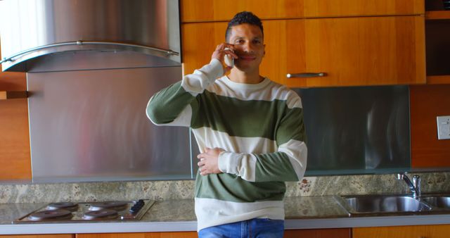 Smiling Man Talking on Mobile Phone in Modern Kitchen - Download Free Stock Images Pikwizard.com