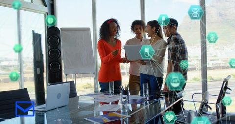 Diverse startup team collaborating in glass office with laptop and digital network overlays