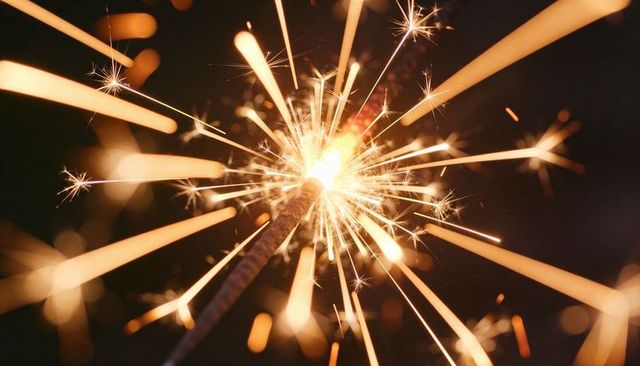 Sparkler Bursting into Golden Sparks and Warm Bokeh Glow, Macro Night Celebration