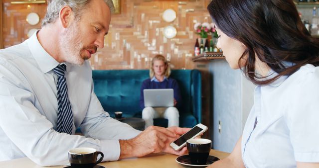 Business Meeting Over Coffee in Modern Cafe Setting - Download Free Stock Images Pikwizard.com