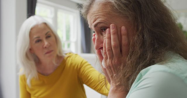 Image of caucasian senior woman crying during support group meeting. togetherness, support, help and seniors mental health.