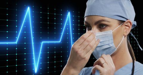 Female Doctor Adjusting Face Mask with Heartbeat Monitor - Download Free Stock Images Pikwizard.com