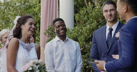 Happy bride and groom sharing joy during outdoor wedding ceremony