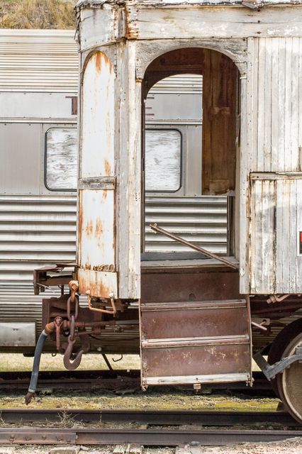 Exterior shot of an old and rusty train car with visible wear and tear, highlighting vintage design and decaying materials. Suitable for concepts relating to history, past transportation, industrial decay, or retro-themed projects.