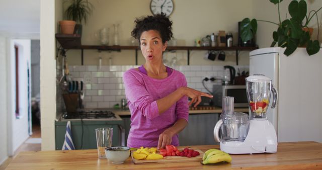 Woman Pointing at Blender While Preparing Healthy Fruit Smoothie in Modern Kitchen - Download Free Stock Images Pikwizard.com