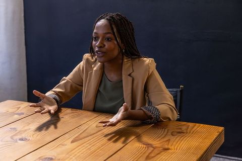 Businesswoman Gesturing During Meeting in Conference Room