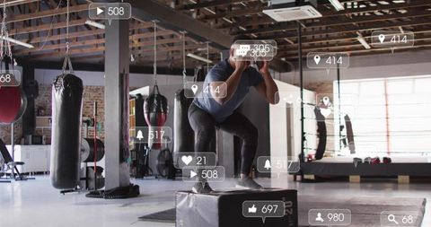 Athlete performing explosive box jumps in modern gym with social media metrics overlays