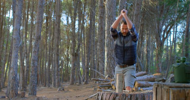 Man Chopping Wood in Forest for Camping Preparation - Download Free Stock Images Pikwizard.com