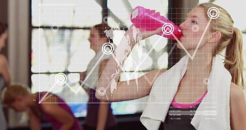 Young woman drinking from pink bottle in gym with hud overlay, towel and workout energy