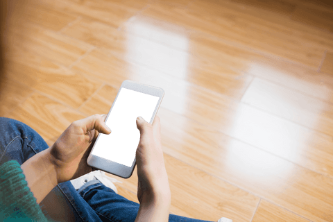Seamless technology: transparent phone screen held by casual woman