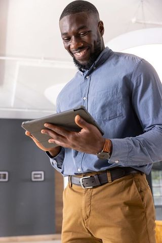 Confident Professional Using Tablet in Modern Office