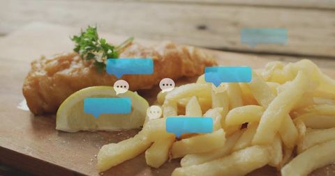 Serving battered fish and thick-cut fries with lemon wedge and blue chat bubbles overlay
