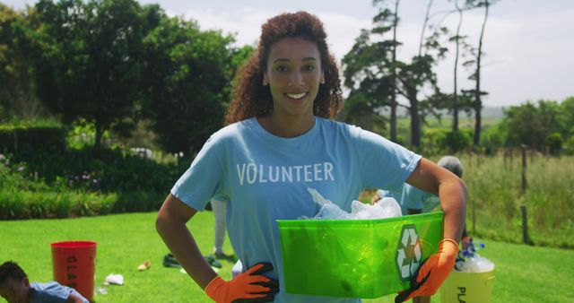 Female volunteer collecting recyclables in green environment - Download Free Stock Images Pikwizard.com