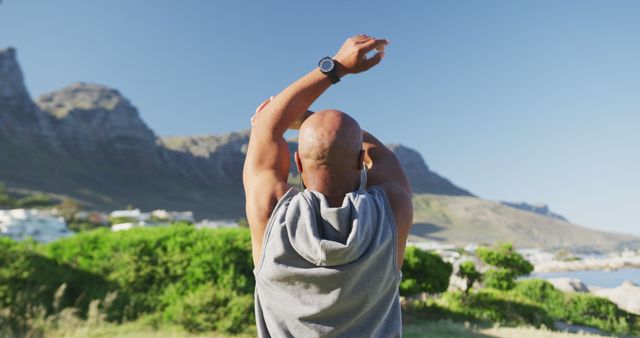 Athletic Man Stretching Outdoors with Mountain View - Download Free Stock Images Pikwizard.com