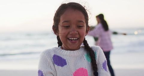 Joyful Child Playing with Sparklers at Sunset Beach