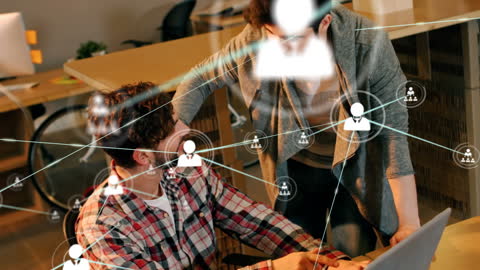 Two Colleagues Discussing Tech Solutions with Network Overlay