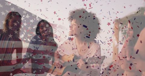 Woman playing acoustic guitar with friends under american flag confetti cozy celebration
