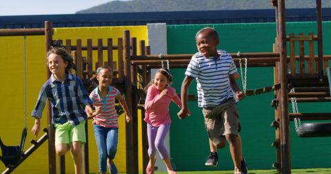 Diverse Kids Joyfully Playing Tag on Vibrant Playground - Download Free Stock Images Pikwizard.com