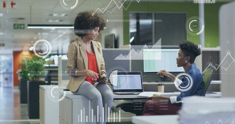 Diverse Colleagues Collaborating on Financial Data in Office