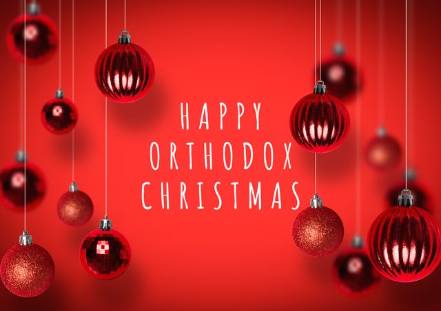 Composition of happy orthodox christmas text with baubles hanging against red background, copy space. orthodox christmas, greeting, tradition and holiday.