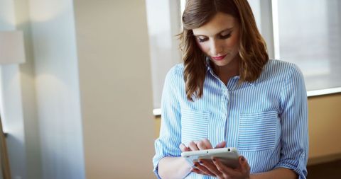 Young Female Executive Engaged with Tablet in Modern Office - Download Free Stock Images Pikwizard.com
