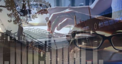 Hands Typing on Laptop Overlayed with Financial Graphs and Buildings