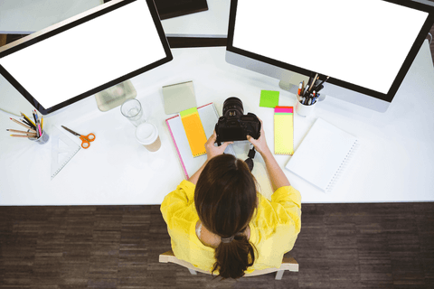 transparent top view woman analyzing digital camera in creative office - Download Free Stock Videos Pikwizard.com
