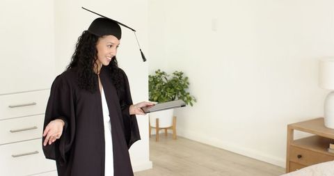 Joyful Graduate Celebrating Achievements with Gift at Home