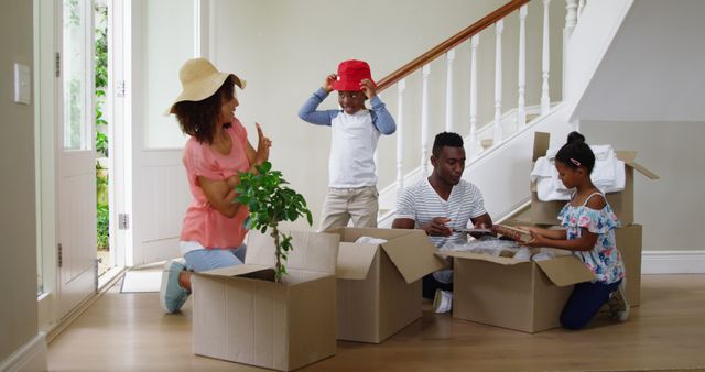 Happy Family Unpacking Boxes in New Home Entrance Hall - Download Free Stock Images Pikwizard.com