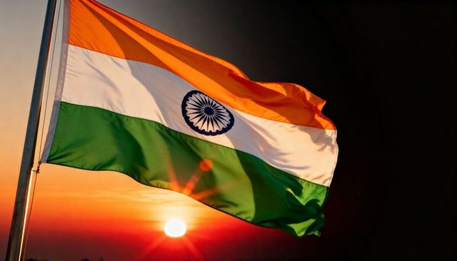 Indian national flag waving at sunset with ashoka chakra backlit by sun and lens flare