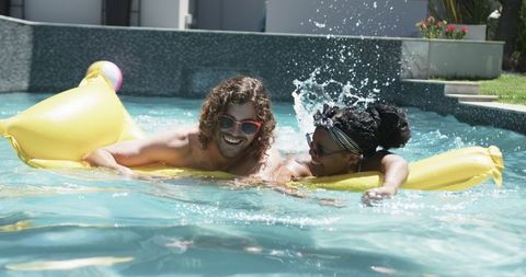 Couple enjoying relaxated summer pool time on inflatable