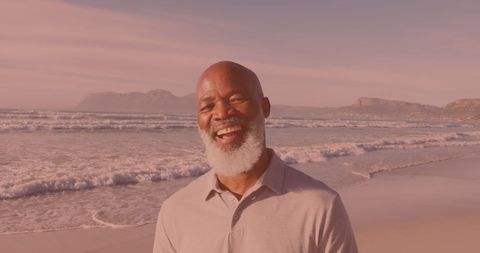 Senior Man Enjoying Peaceful Beach Walk at Sunset