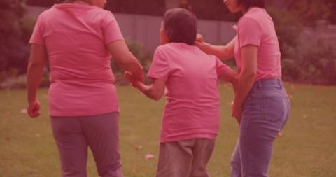 Caring Korean Family Women Supporting Senior Outside on a Sunny Day